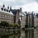 The Binnenhof sits on the edge of a lake with a clock tower in the background
